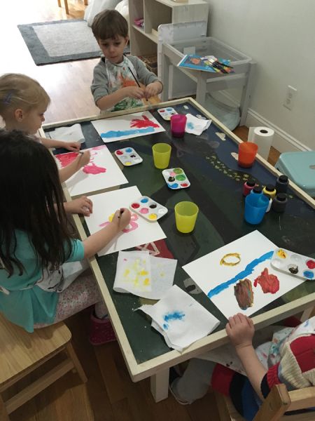 young students painting at Little Bee Learning Studio